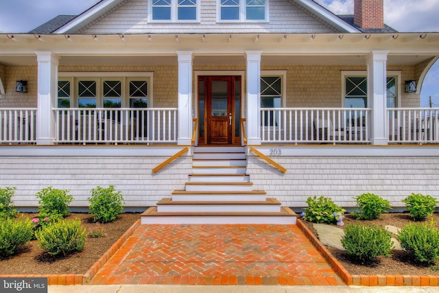 view of front of property with a chimney and a porch