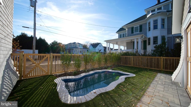 view of pool with a fenced backyard, a gate, and a lawn