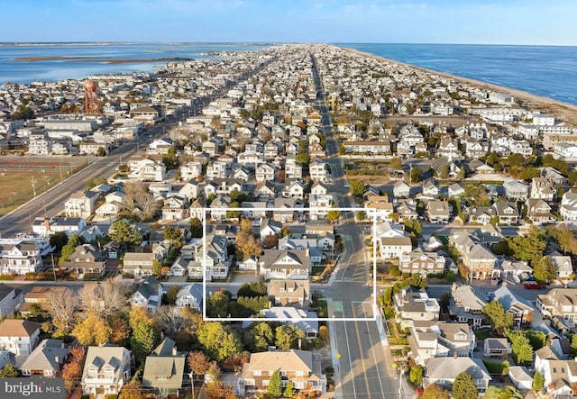 birds eye view of property with a water view and a residential view