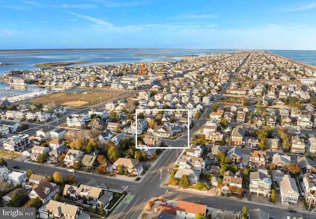 drone / aerial view with a water view and a residential view