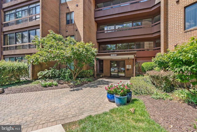 view of exterior entry with brick siding