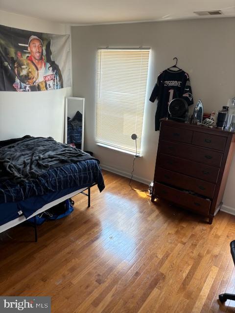 bedroom featuring multiple windows and light hardwood / wood-style flooring