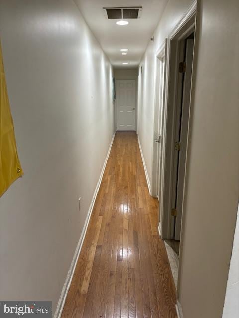 corridor with wood-type flooring