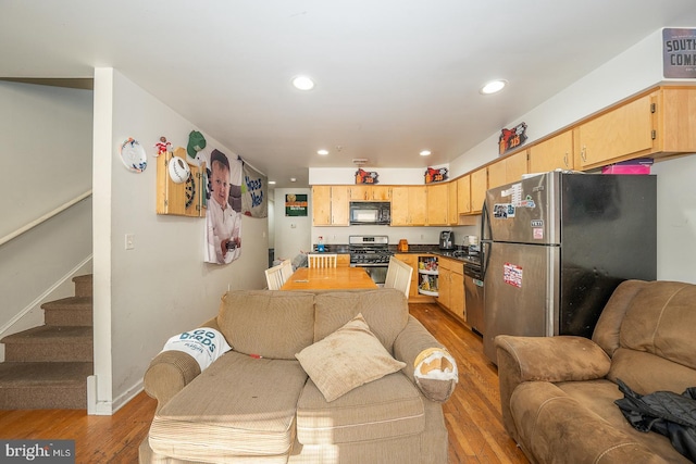 living room with light hardwood / wood-style floors and sink