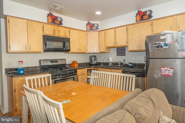 kitchen with appliances with stainless steel finishes, light brown cabinets, and sink