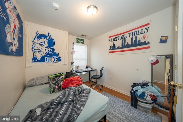 bedroom featuring wood-type flooring