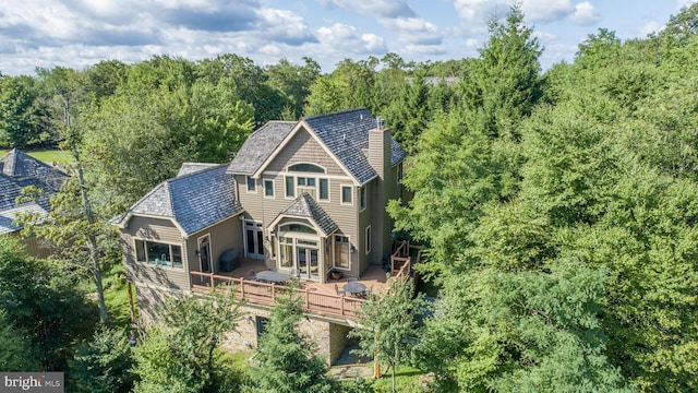 back of house featuring a deck