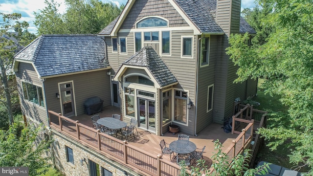 rear view of property with french doors and a deck