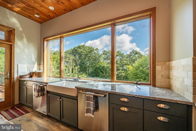 kitchen with light stone counters, wooden ceiling, a healthy amount of sunlight, and wood-type flooring