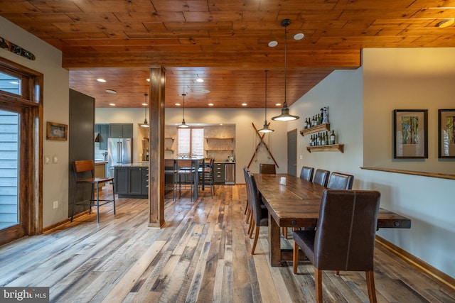 dining space featuring wood-type flooring and wood ceiling