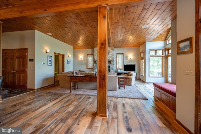 interior space featuring a fireplace, hardwood / wood-style floors, and wooden ceiling