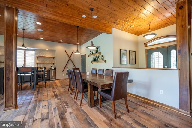 dining room with dark hardwood / wood-style flooring, wood ceiling, and a wealth of natural light