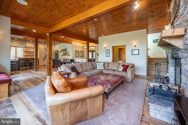 living room with beam ceiling, wooden ceiling, and wood-type flooring