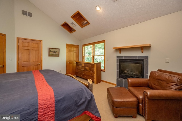 carpeted bedroom featuring a fireplace, high vaulted ceiling, and a textured ceiling