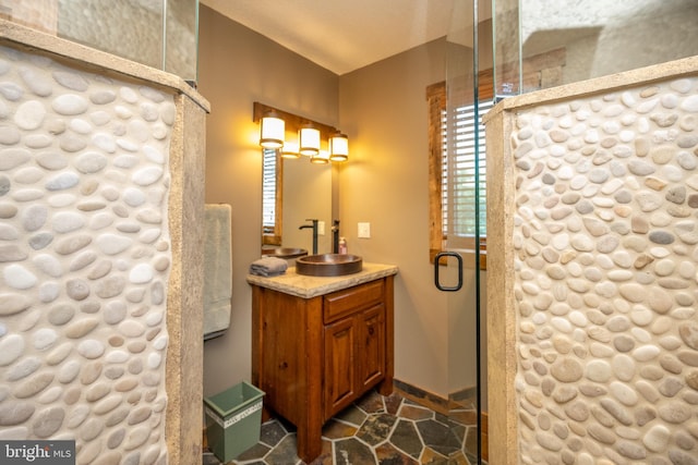 bathroom with vanity and a shower with shower door