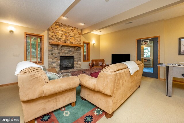 carpeted living room featuring a stone fireplace