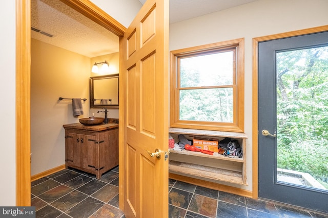 bathroom featuring vanity and a textured ceiling