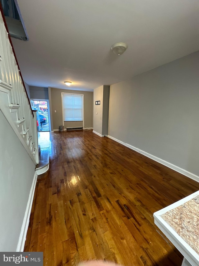 unfurnished living room featuring dark hardwood / wood-style floors