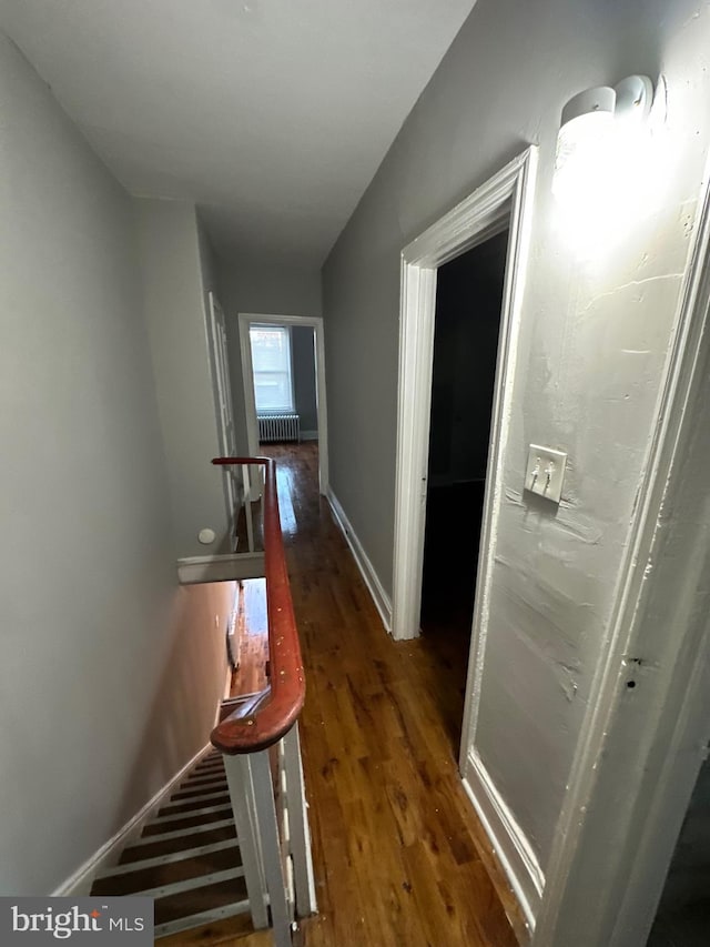 corridor featuring dark hardwood / wood-style floors and radiator