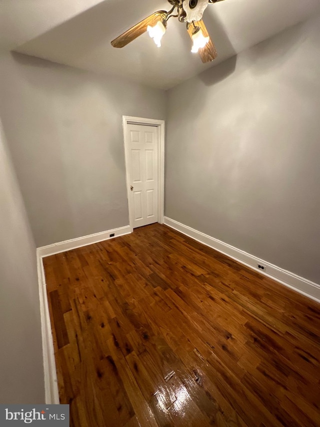 spare room featuring ceiling fan and dark hardwood / wood-style floors