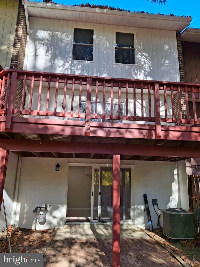 rear view of house featuring central AC unit and a deck