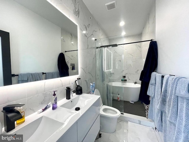 full bathroom featuring shower with separate bathtub, tile walls, tile patterned flooring, vanity, and toilet