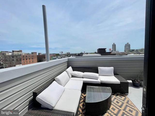 view of patio featuring an outdoor hangout area and a balcony