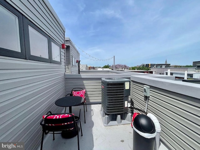 view of patio with a balcony and cooling unit