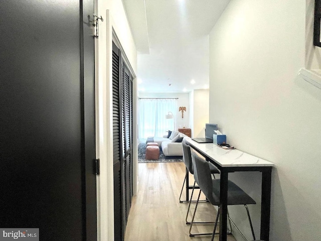 hallway with light hardwood / wood-style flooring