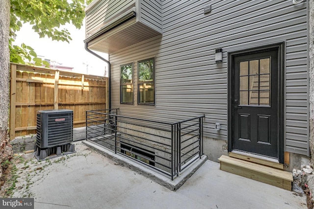 entrance to property with cooling unit and a patio area