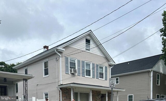 view of front of property with cooling unit and a porch