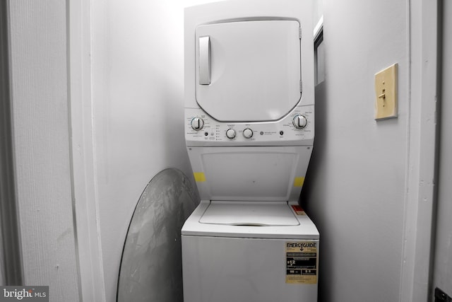 laundry area featuring stacked washer / dryer