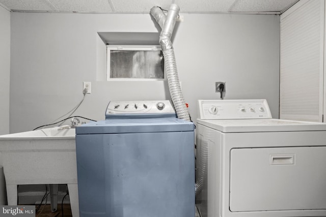 clothes washing area with sink and separate washer and dryer