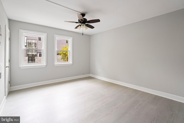 spare room featuring ceiling fan and light wood-type flooring