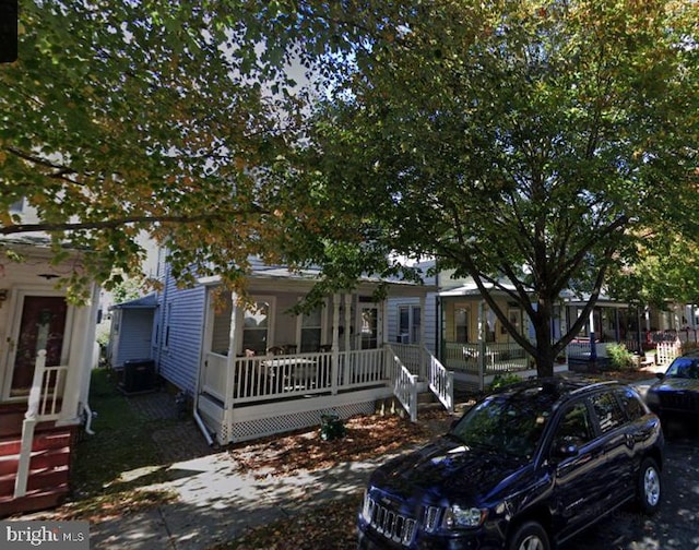 view of front of property with a porch and cooling unit