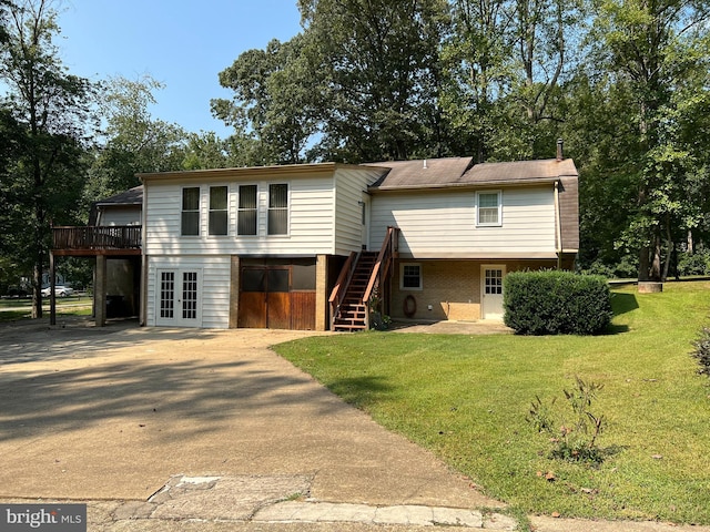 view of front of home with french doors, a deck, and a front yard