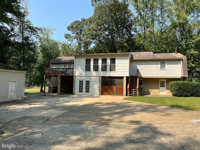 view of front property featuring french doors and a wooden deck