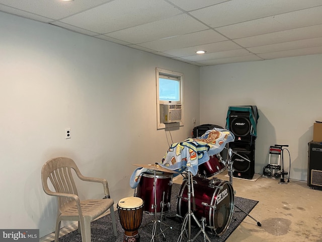 misc room featuring a drop ceiling, concrete floors, and cooling unit