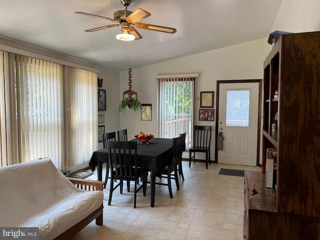 dining room featuring lofted ceiling, light tile patterned floors, and ceiling fan