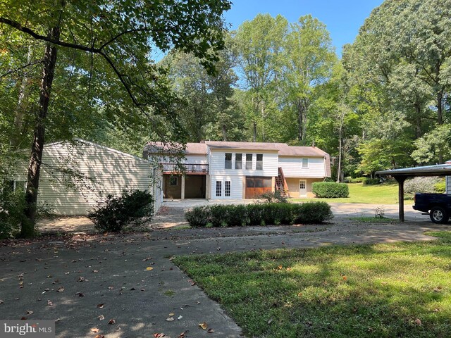 view of front facade with a front yard and a carport