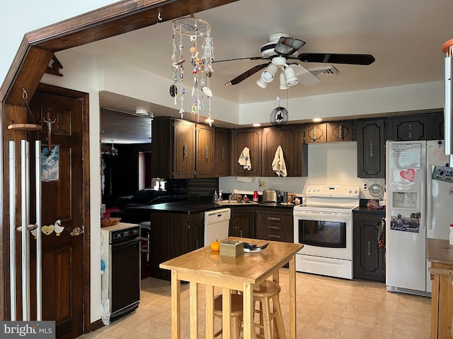 kitchen featuring ceiling fan, dark brown cabinets, white appliances, and light tile patterned floors