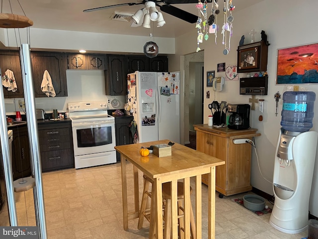 kitchen featuring ceiling fan, dark brown cabinetry, white appliances, and light tile patterned floors