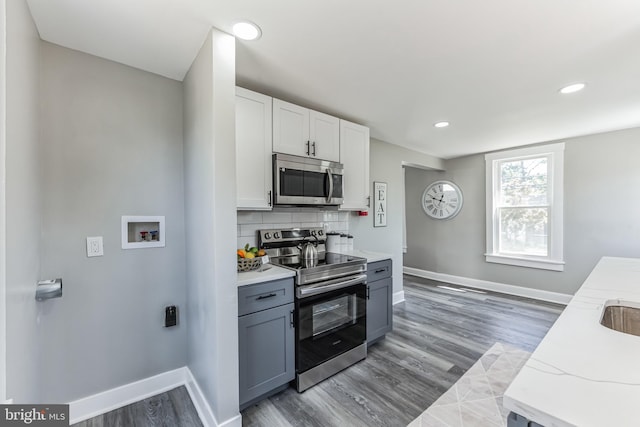 89 E Barber Ave, Woodbury, NJ 08096 - kitchen featuring baseboards, stainless steel appliances, backsplash, and white cabinets