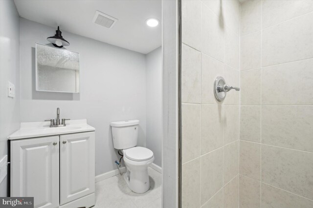 bathroom with tile patterned flooring, toilet, and vanity