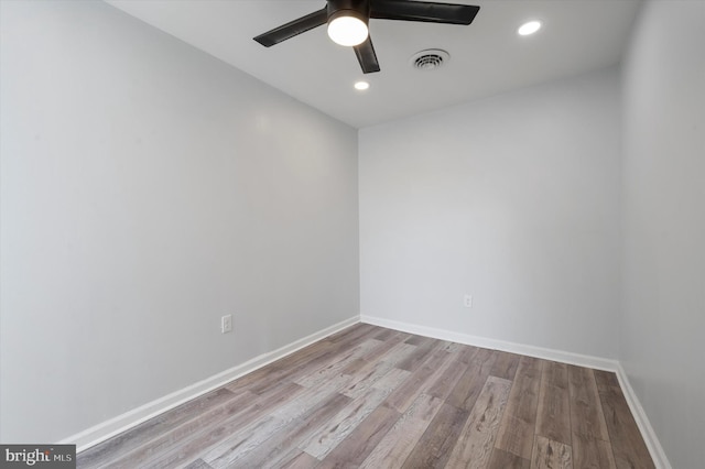 empty room with ceiling fan and hardwood / wood-style floors