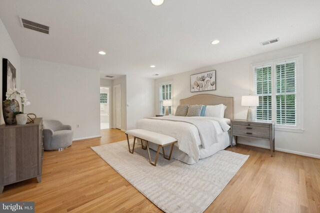 bedroom with light hardwood / wood-style flooring and multiple windows