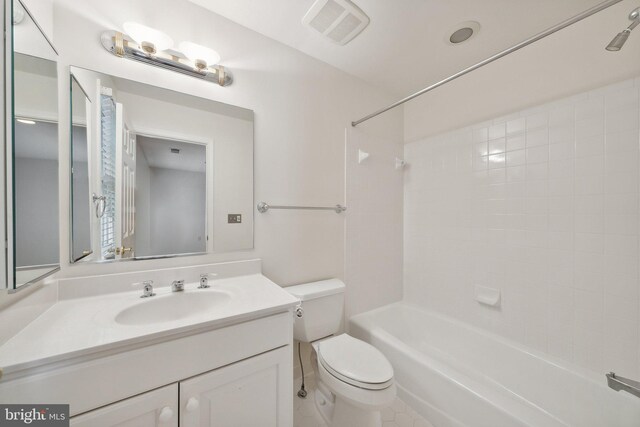 full bathroom featuring tiled shower / bath, vanity, and toilet