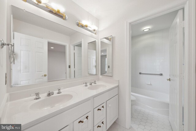 bathroom featuring tile patterned flooring, vanity, and toilet