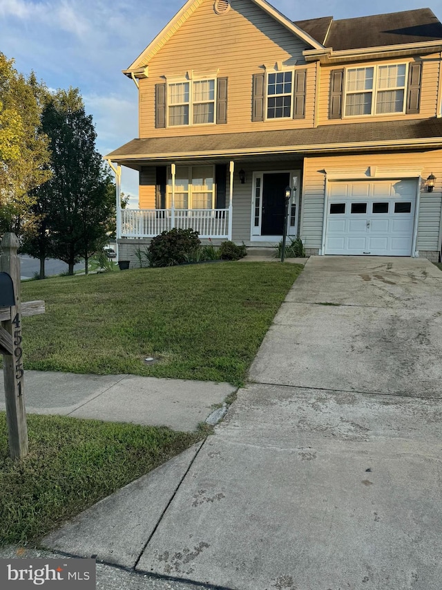 view of front facade with a garage, a front yard, and a porch