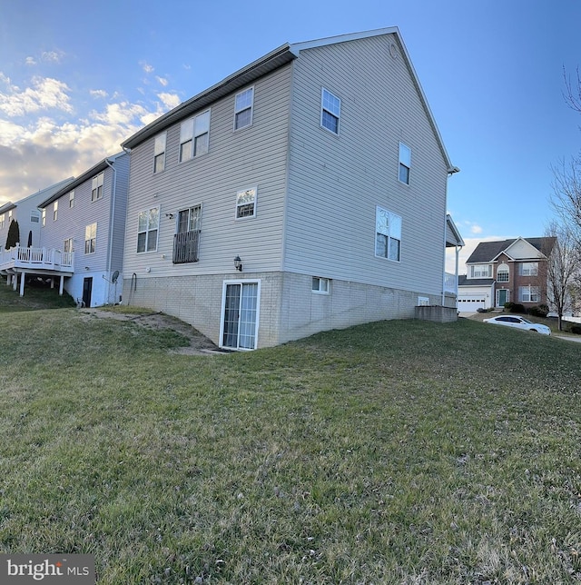 rear view of property featuring a yard and a garage